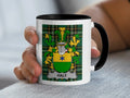 White mug with black rim displaying a coat of arms with the name Haly.