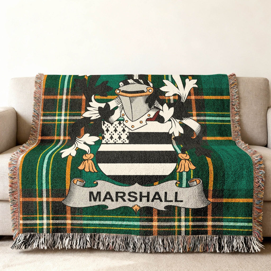 Marshall family crest on a green plaid woven throw blanket with fringe.