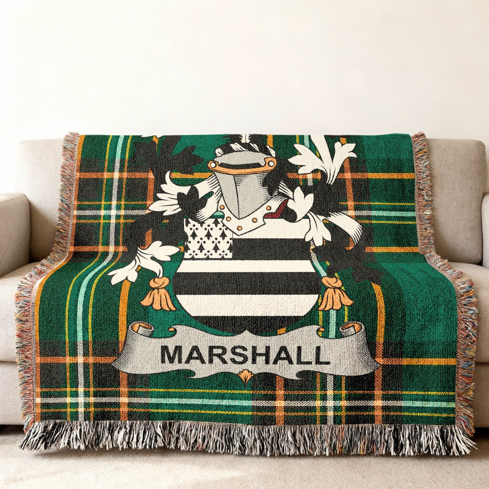 Marshall family crest on a green plaid woven throw blanket with fringe.