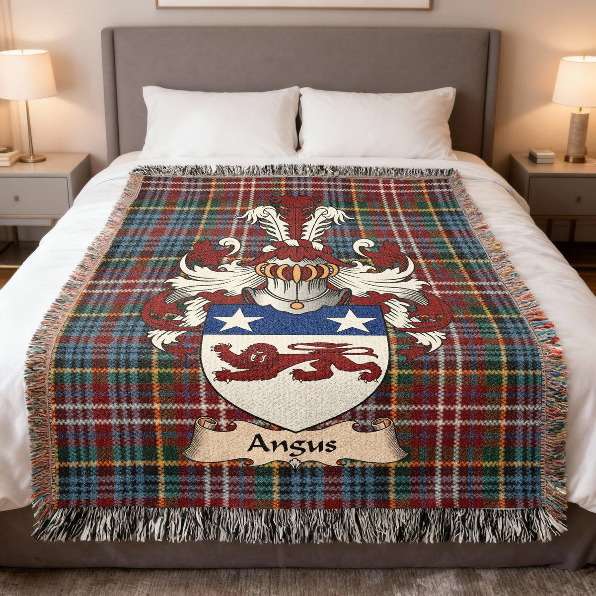 Angus Scottish family crest woven blanket on a Caledonia tartan background, displayed on a bed