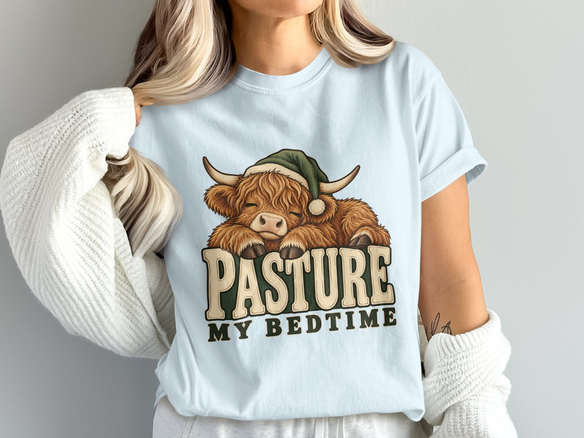 Model wearing the Pasture My Bedtime Highland cow Comfort Colors T-shirt in Chambray