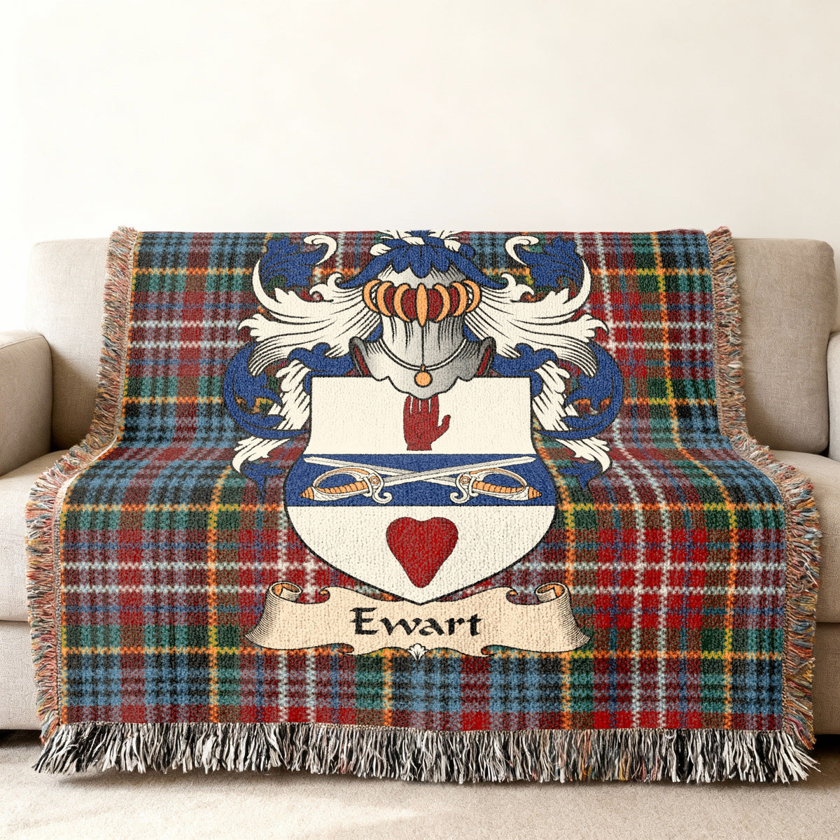 Ewart family crest emblem on a Caledonia tartan woven blanket