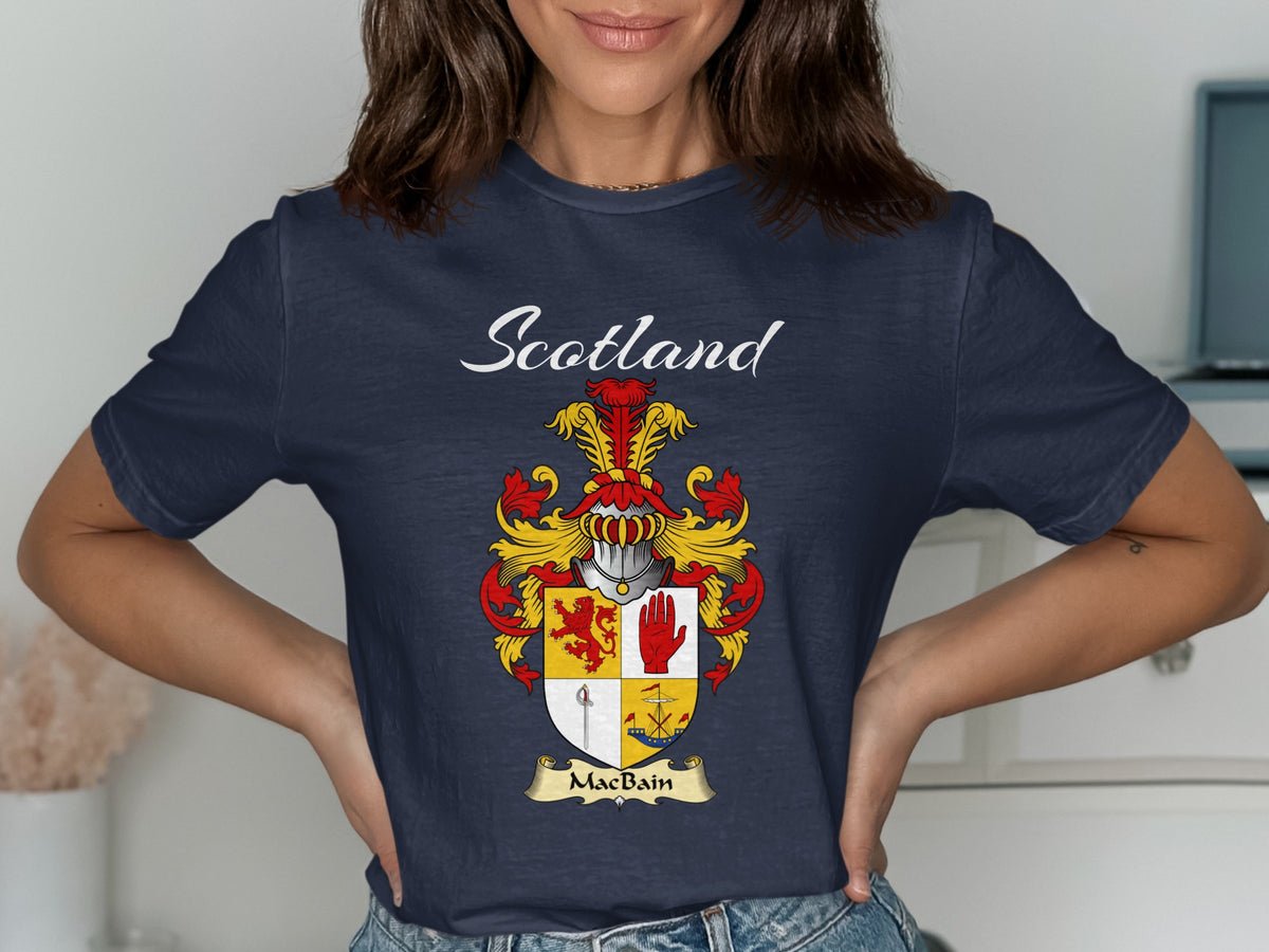 Model wearing a navy MacBain T-shirt featuring a quartered shield featuring a red lion and an upright hand