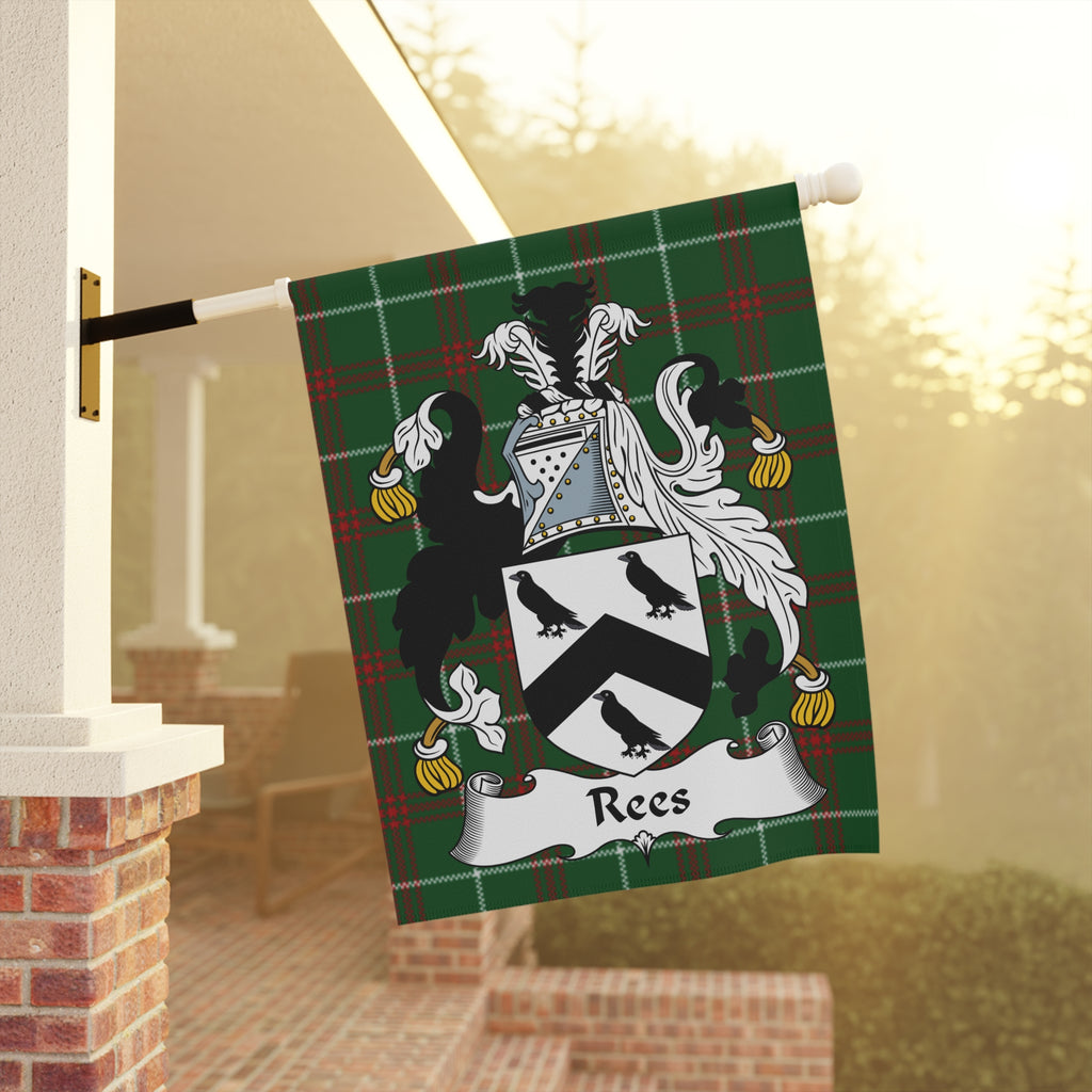 Rees family crest on a green tartan flag displayed outside a home.