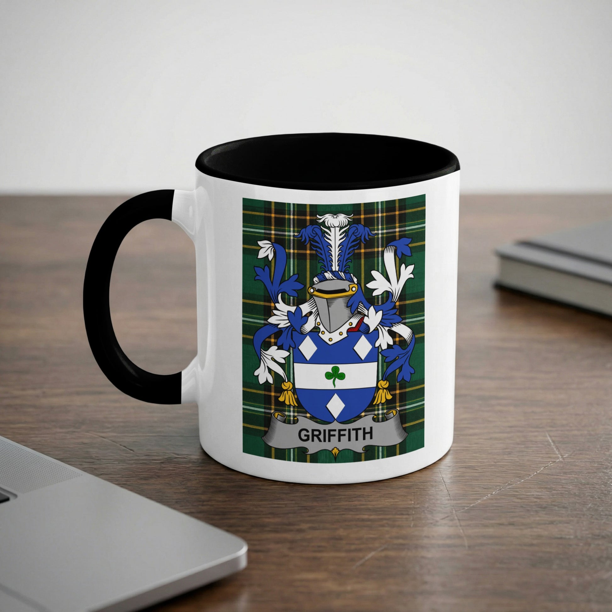 White mug with black rim featuring a blue, green, and yellow heraldic crest with the name "GRIFFITH" below.