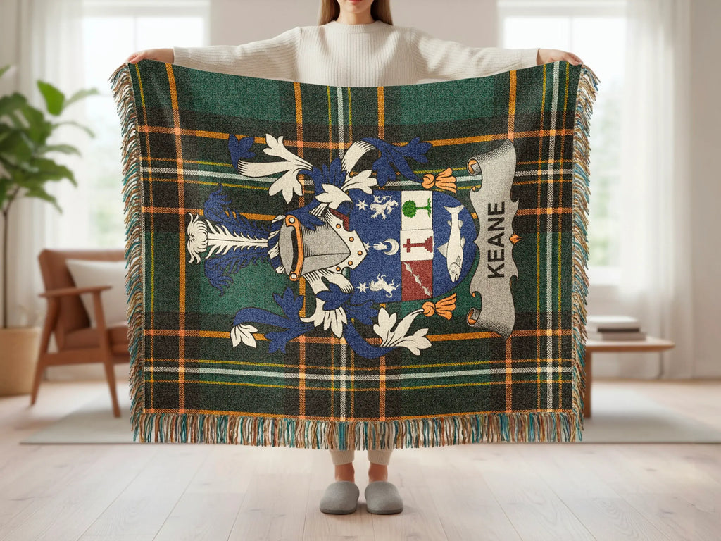 Tartan blanket with Keane family crest displayed by person.