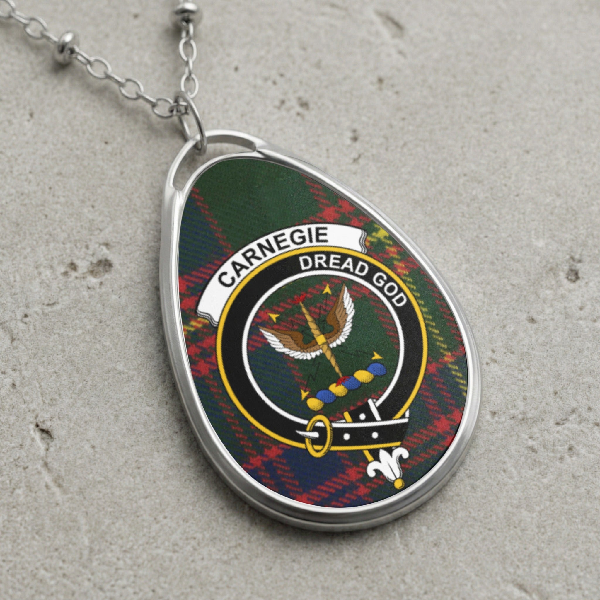 Carnegie clan Scottish tartan necklace with clan crest and Dread God motto on tartan background