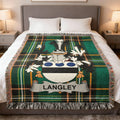 Tartan blanket with Langley family crest on a bed.