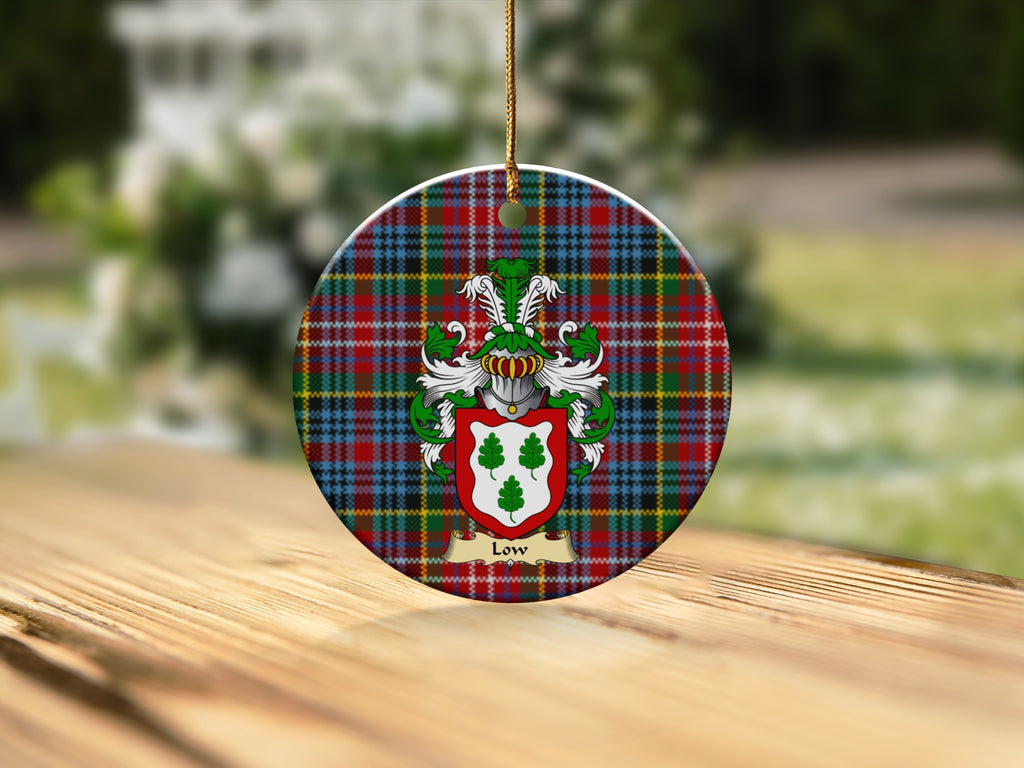 Round Low Scottish clan ornament with family crest on a Caledonia tartan background