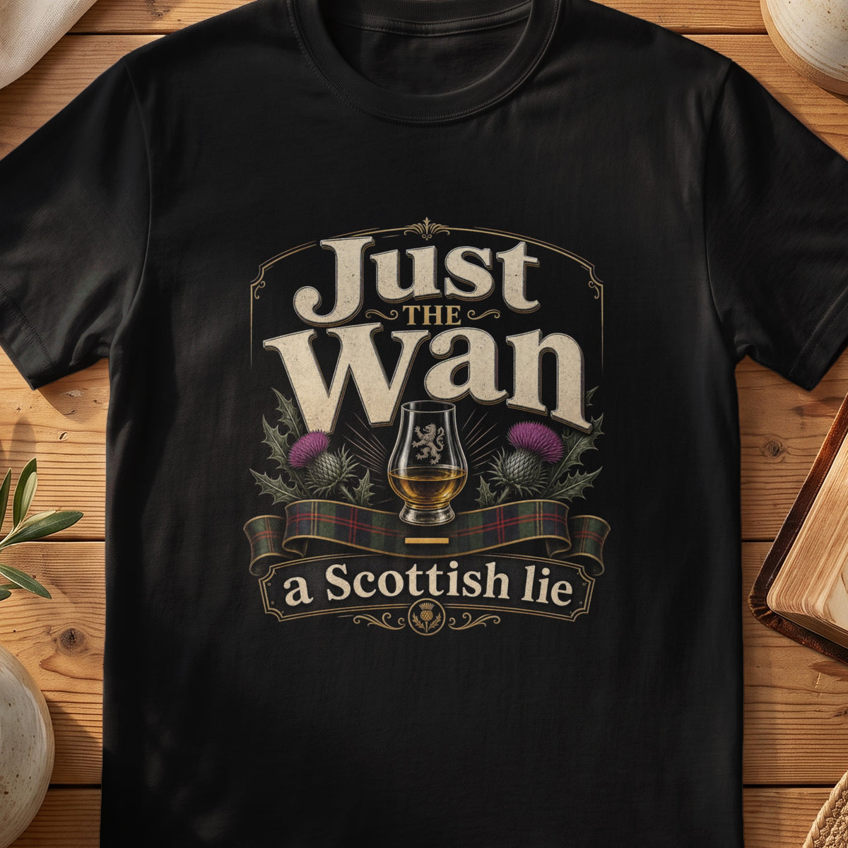 Black Gildan 64000 unisex T-shirt flatlay with Just the Wan A Scottish Lie Scottish graphic design