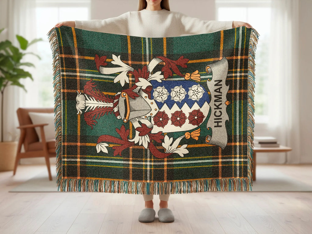 Green tartan throw blanket with Hickman family crest displayed.