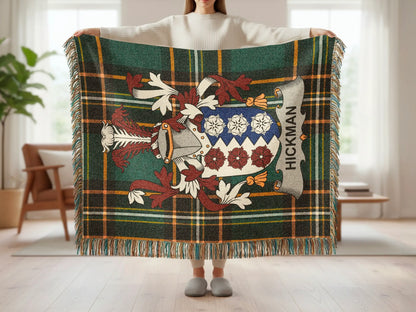 Green tartan throw blanket with Hickman family crest displayed.