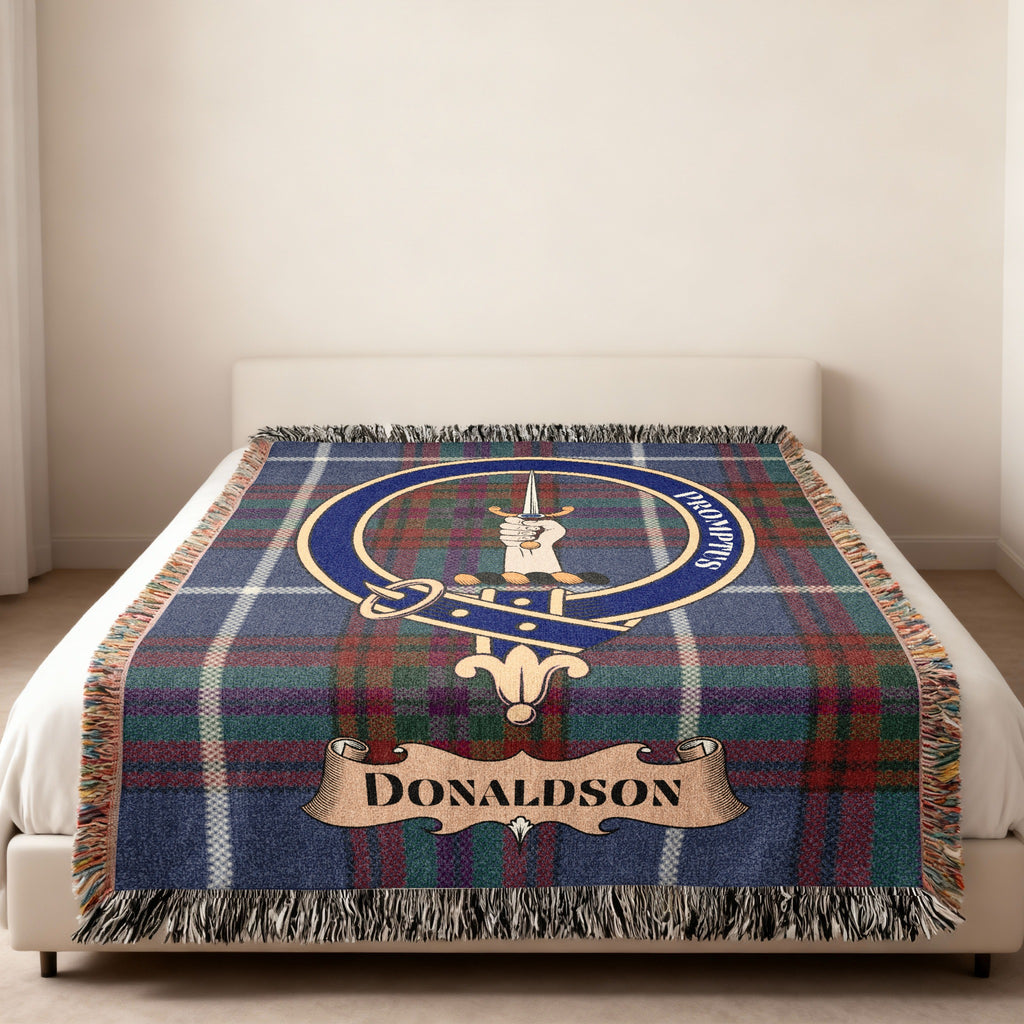 Donaldson family crest and motto woven into tartan blanket — close-up