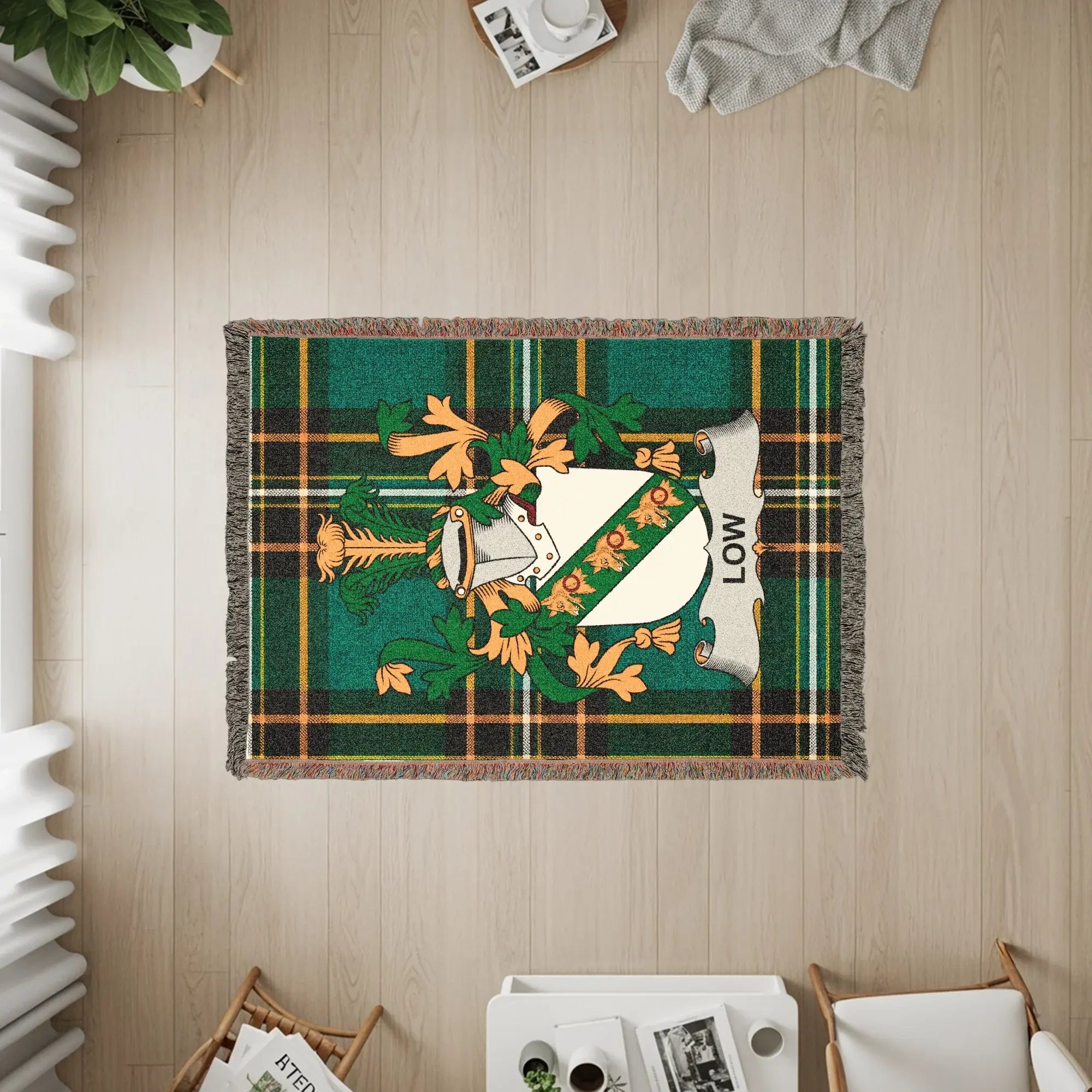 Green plaid throw blanket with a crest and the name "Low".