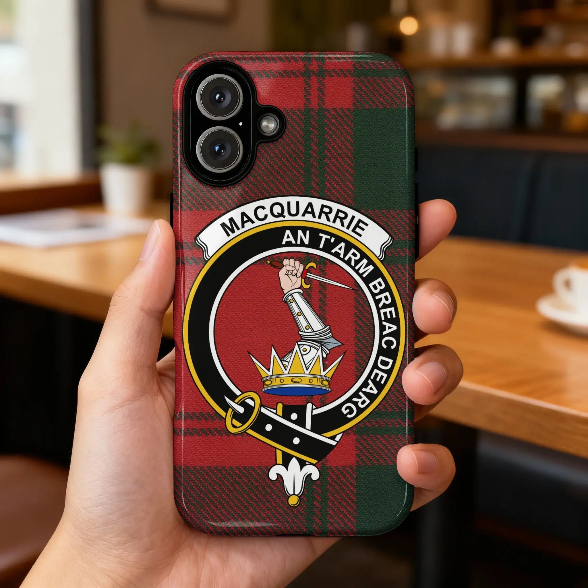 Clan MacQuarrie tartan case on iPhone — full-colour crest wrap, precise port cutouts, glossy surface