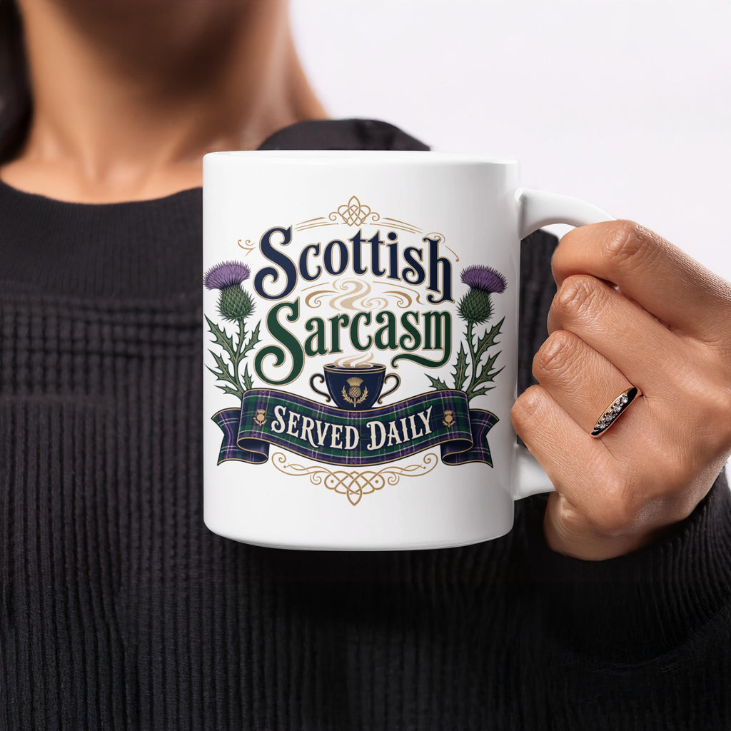 White mug with "Scottish Sarcasm Served Daily" text and thistle design.