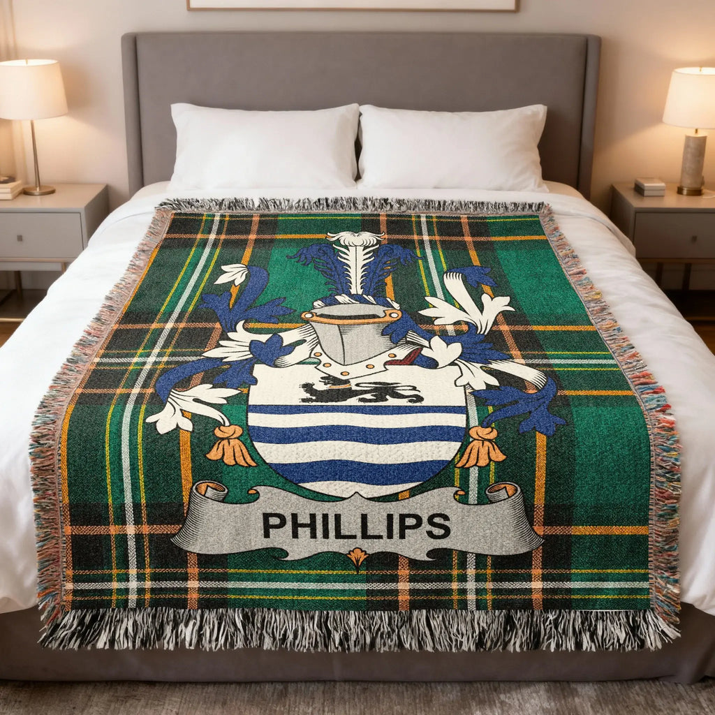 Plaid blanket with Phillips family crest on a bed.