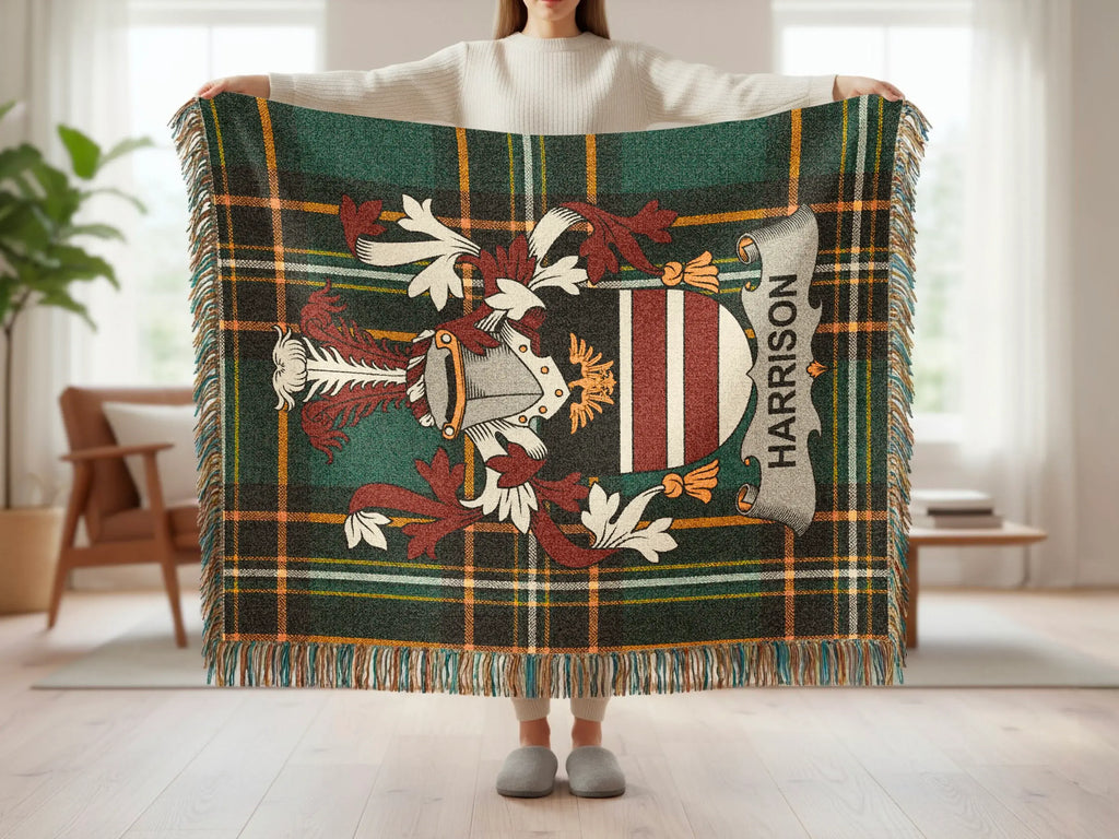 Tartan blanket with a crest and "Harrison" text, held by a person.