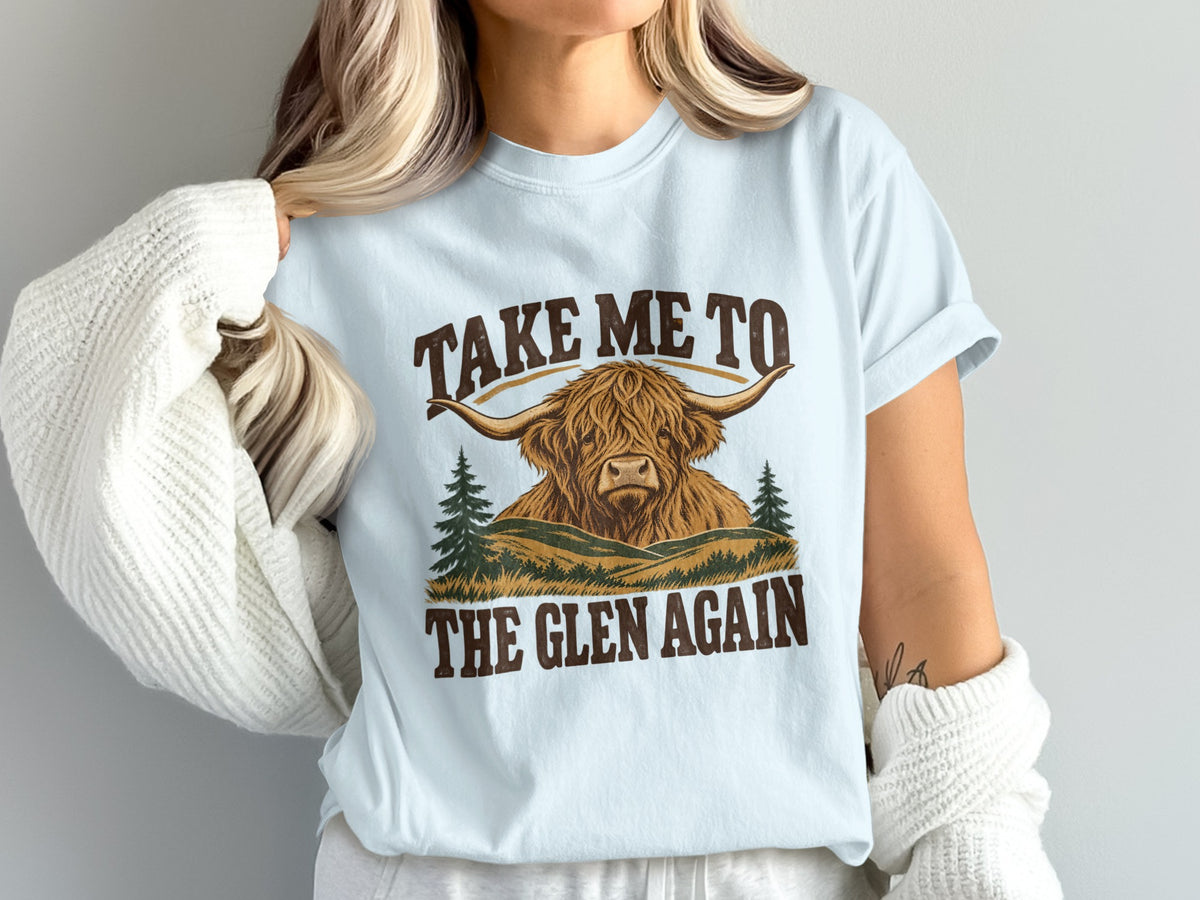 Model wearing the Take Me to the Glen Again Highland cow Comfort Colors T-shirt in Chambray