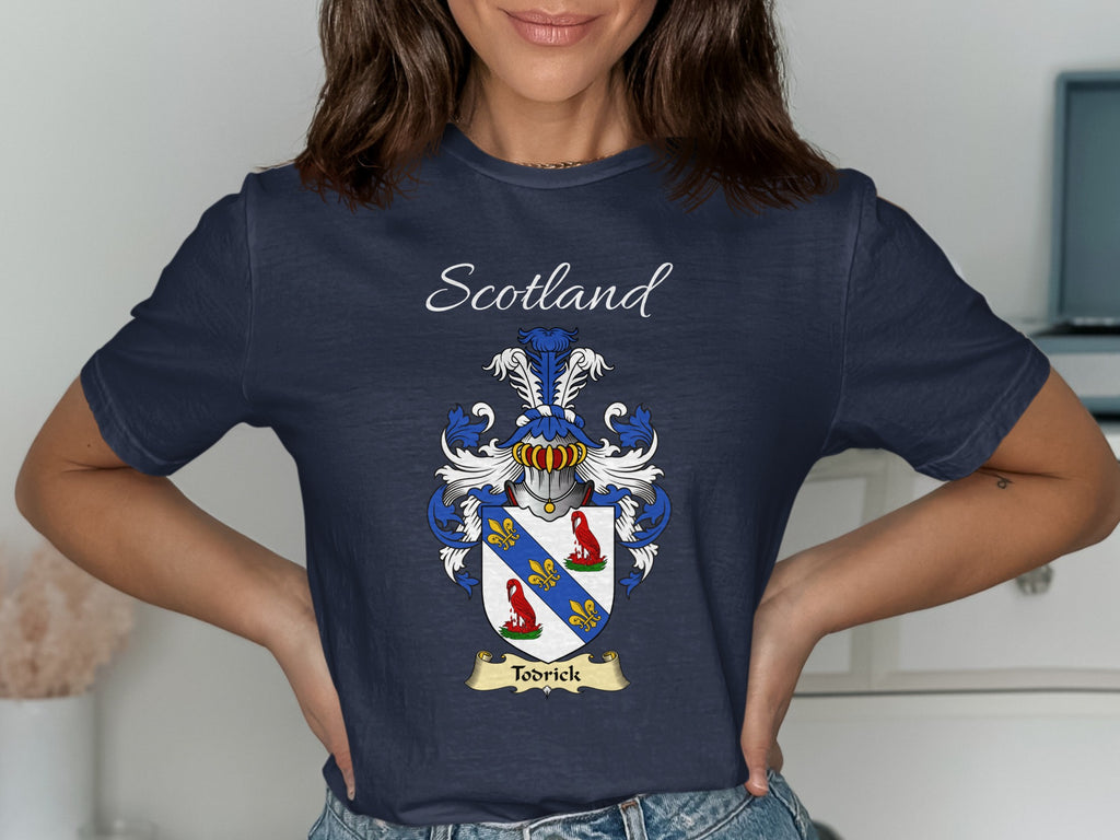 Model wearing the navy Todrick family crest T-shirt featuring “Scotland” and the surname banner.