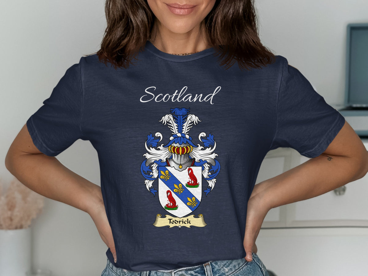 Model wearing the navy Todrick family crest T-shirt featuring “Scotland” and the surname banner.