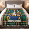 Wray family crest on a green plaid throw blanket draped on a bed.
