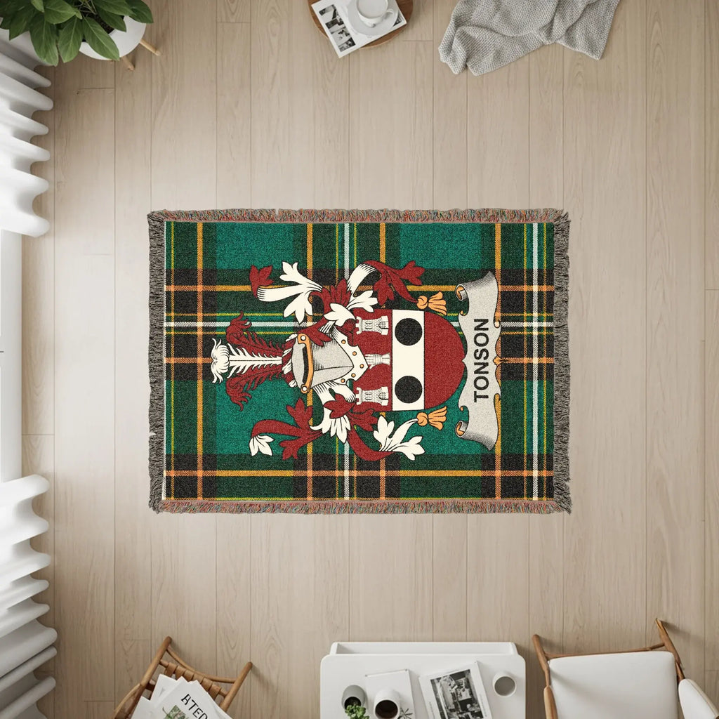 Tonson family crest woven on a green plaid throw blanket.