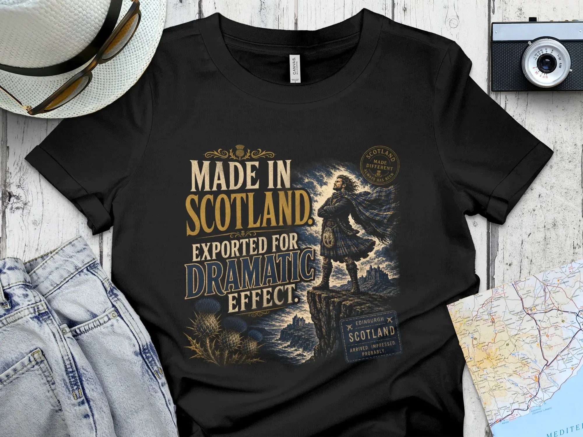 Black t-shirt with "Made in Scotland Exported for Dramatic Effect" slogan.