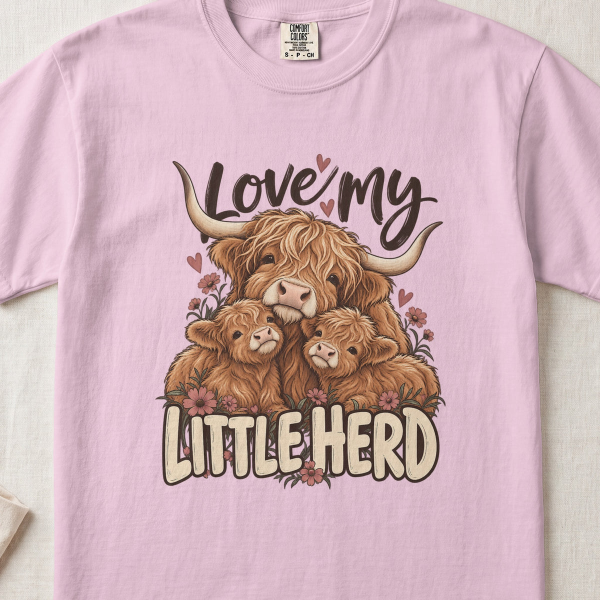 Love My Little Herd Highland cow design on a Blossom Comfort Colors 1717 T-shirt, flat lay