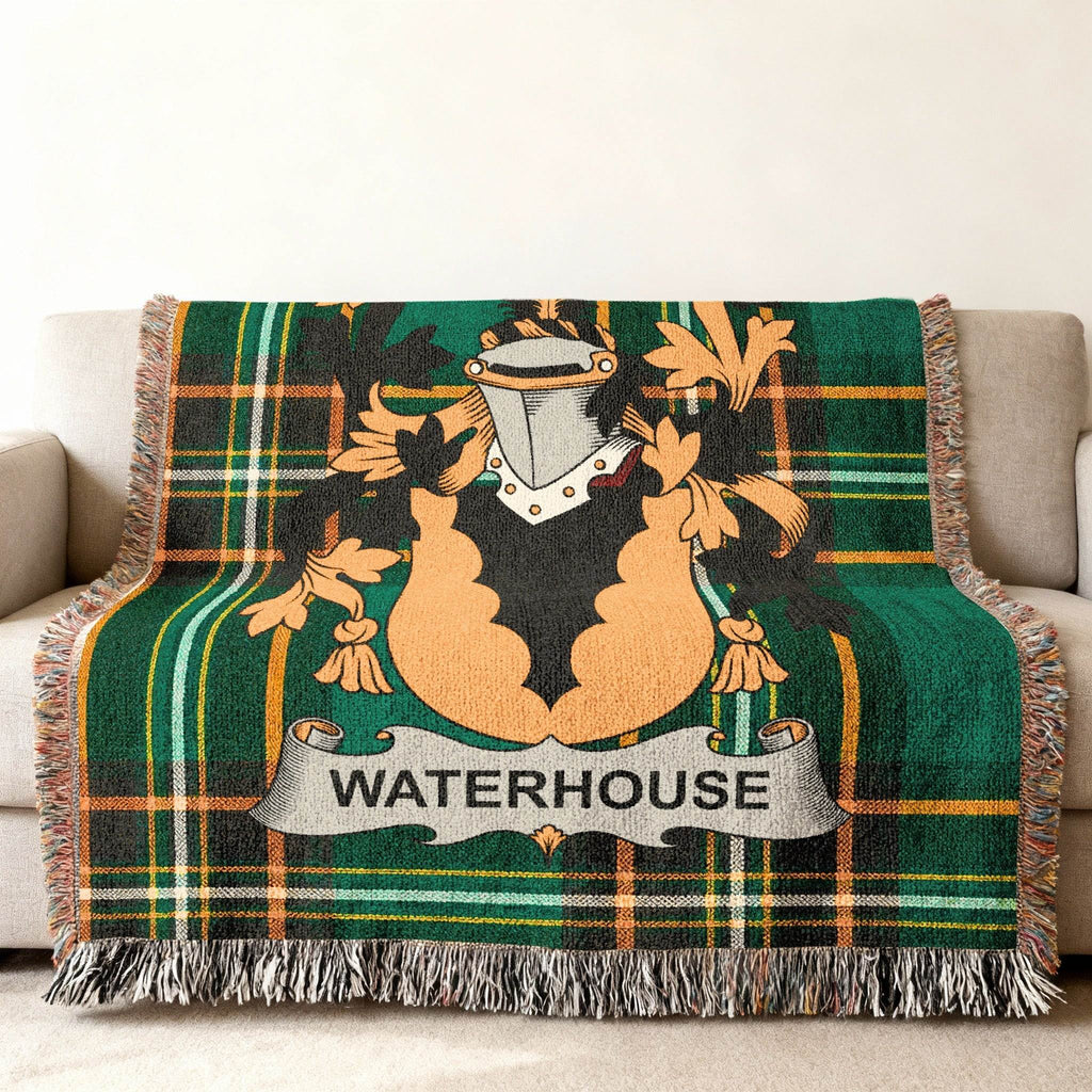 Green tartan blanket with "WATERHOUSE" crest draped over a sofa.