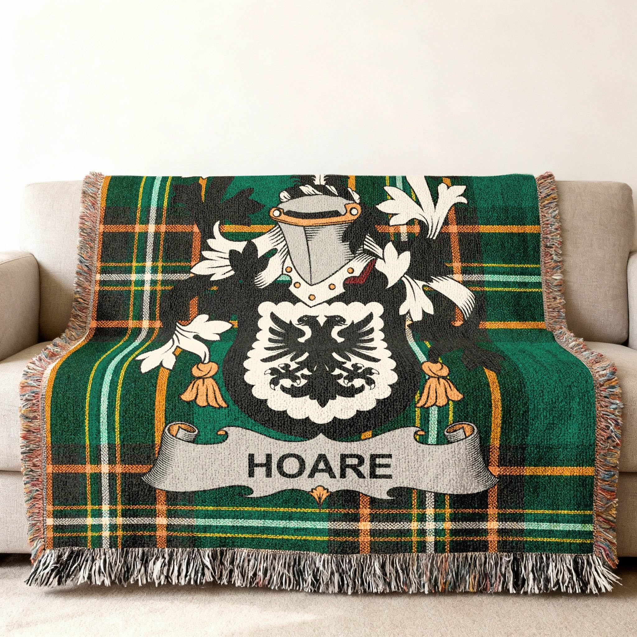 Green tartan blanket with Hoare coat of arms draped over a sofa.