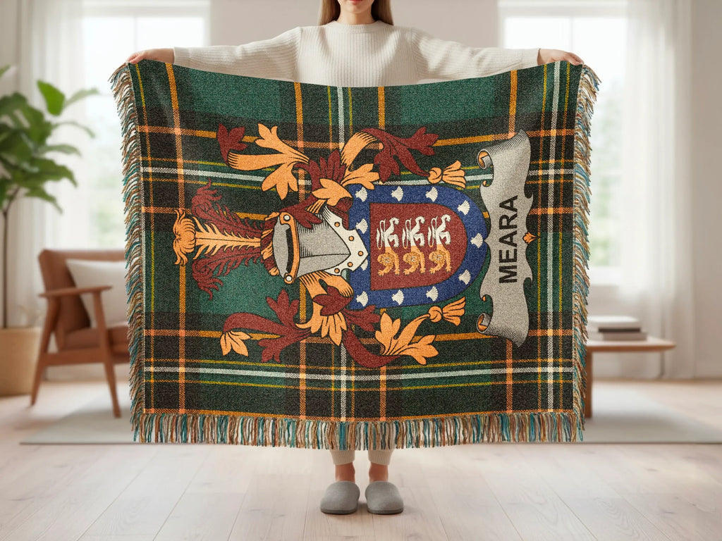 Tartan blanket with a coat of arms and "MEARA" text.