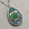 Irvine clan Scottish tartan necklace with clan crest and Sub Sole Sub Umbra Virens motto on tartan background