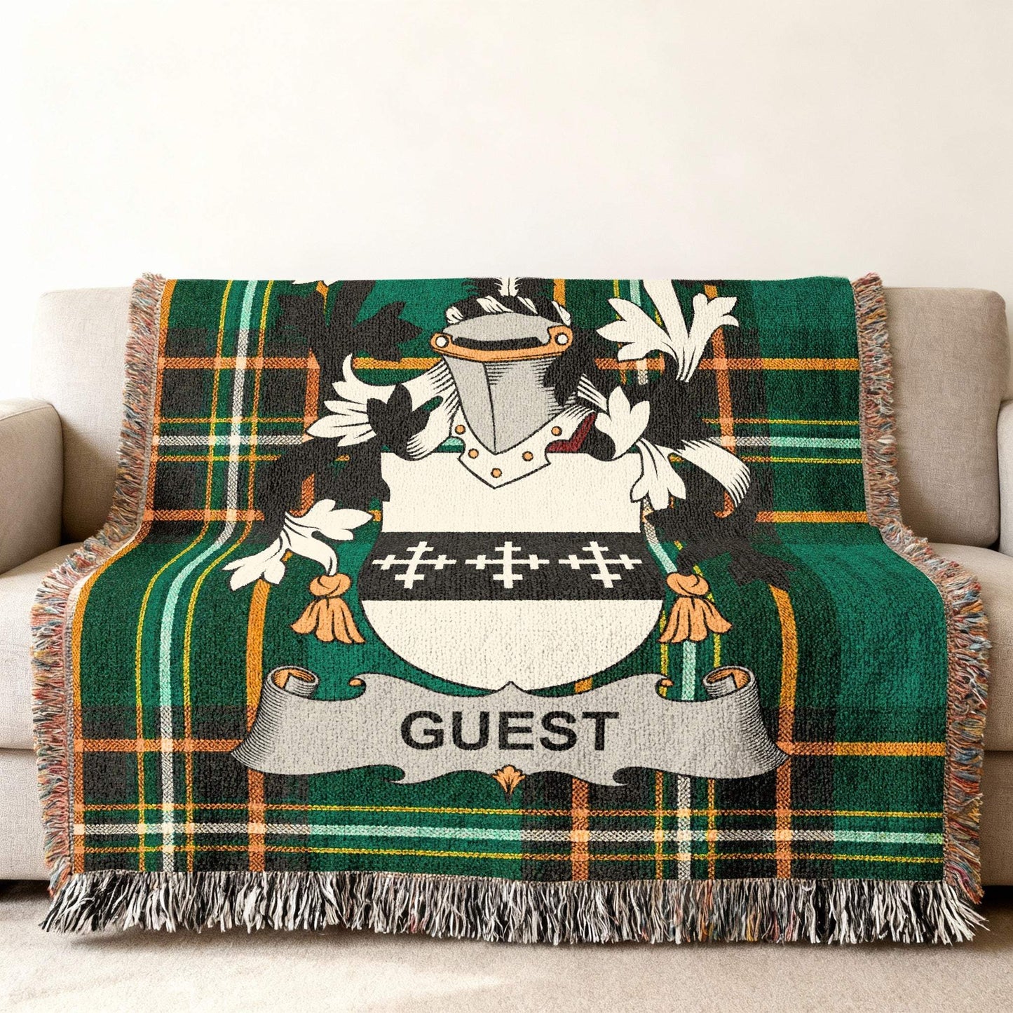 Green plaid blanket with a family crest displaying "GUEST".