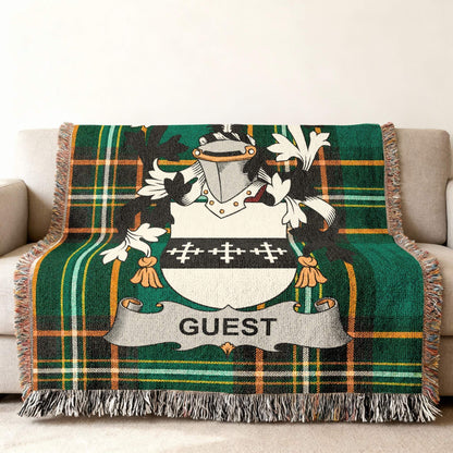 Green plaid blanket with a family crest displaying "GUEST".