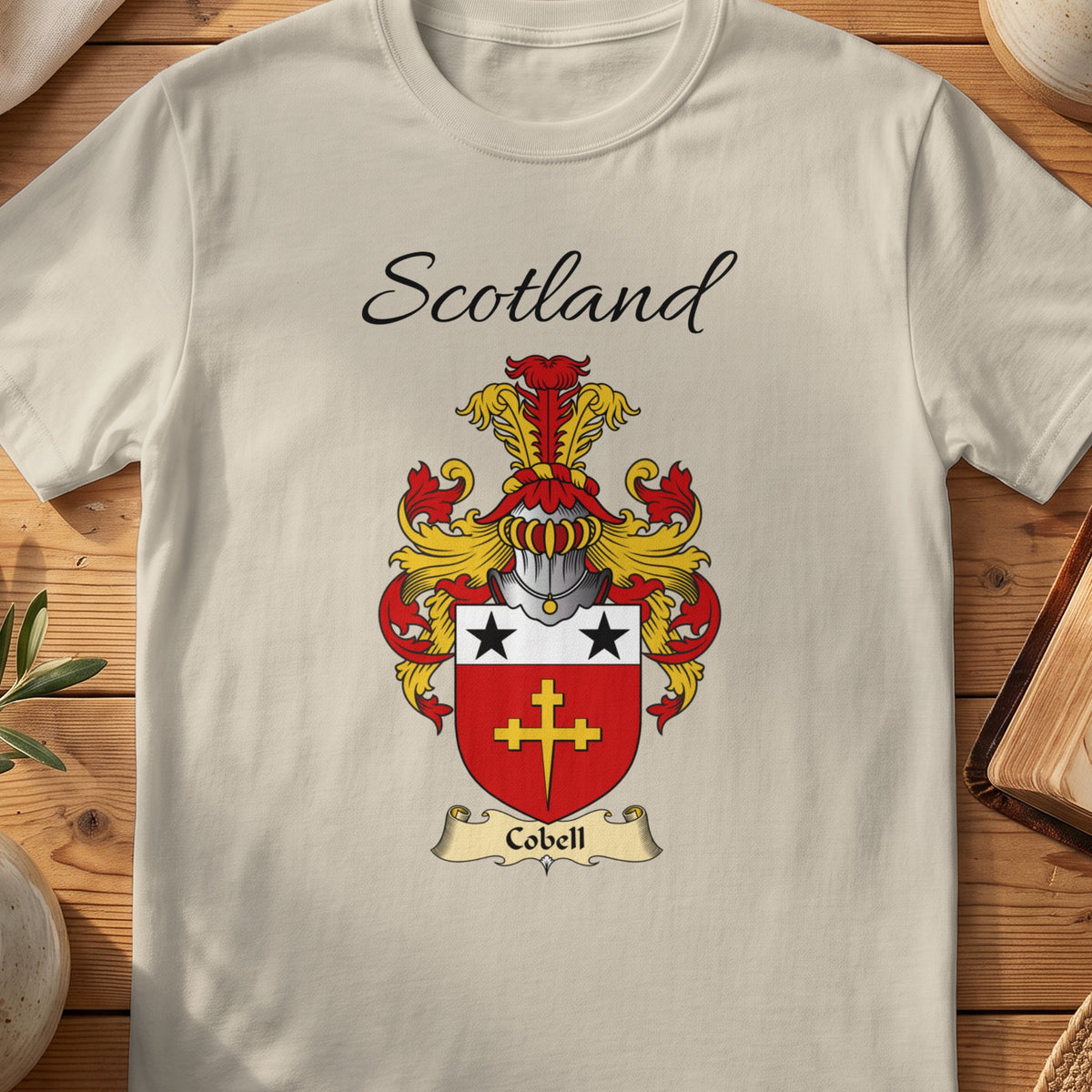 Sand Cobell Scottish family shield T-shirt featuring a gold cross beneath black stars on red
