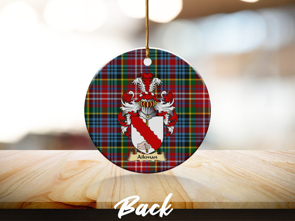 Round Aikman Scottish clan ornament with family crest on a Caledonia tartan background