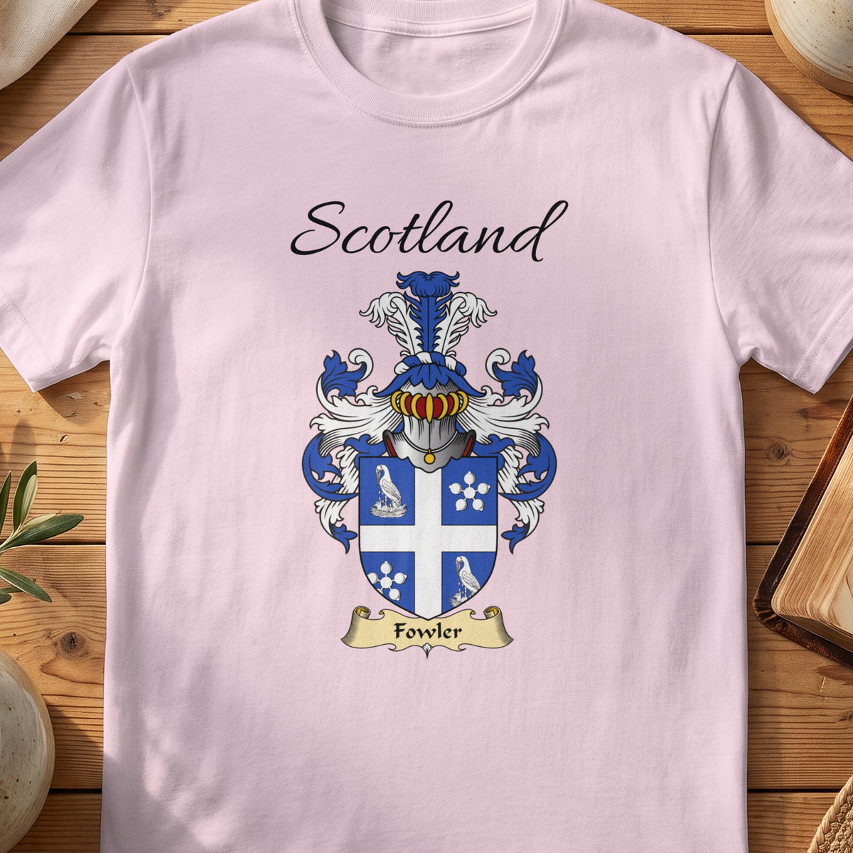 Light Pink Fowler Scottish family shield T-shirt featuring a white cross separating bird and flower motifs