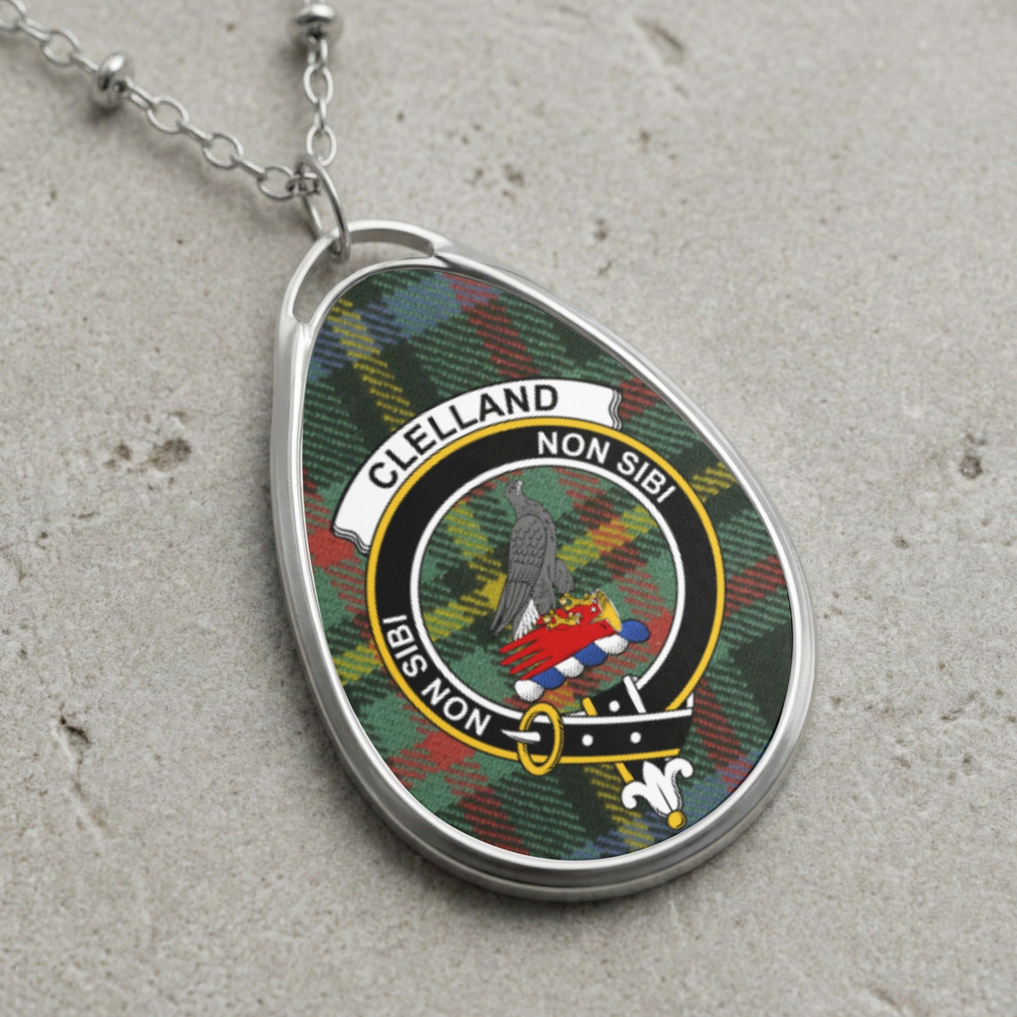 Clelland clan Scottish tartan necklace with clan crest and Non Sibi motto on tartan background
