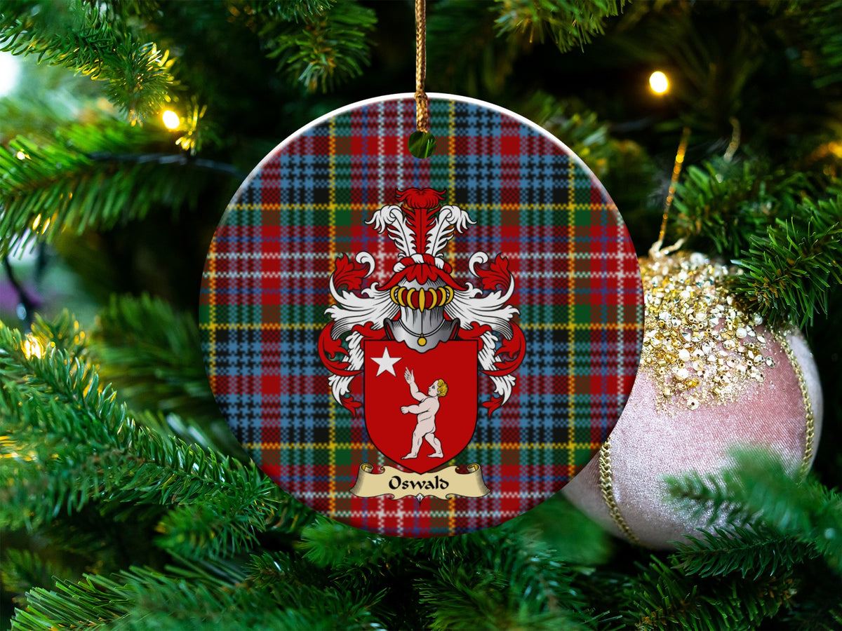 Oswald Scottish clan ceramic ornament with family crest on a Caledonia tartan background, hanging on a Christmas tree