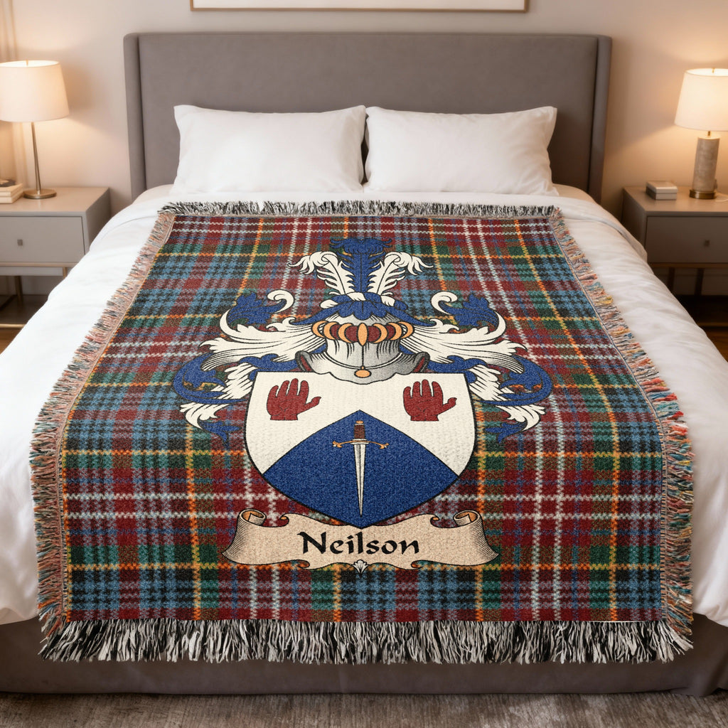 Neilson family crest emblem on a Caledonia tartan woven blanket