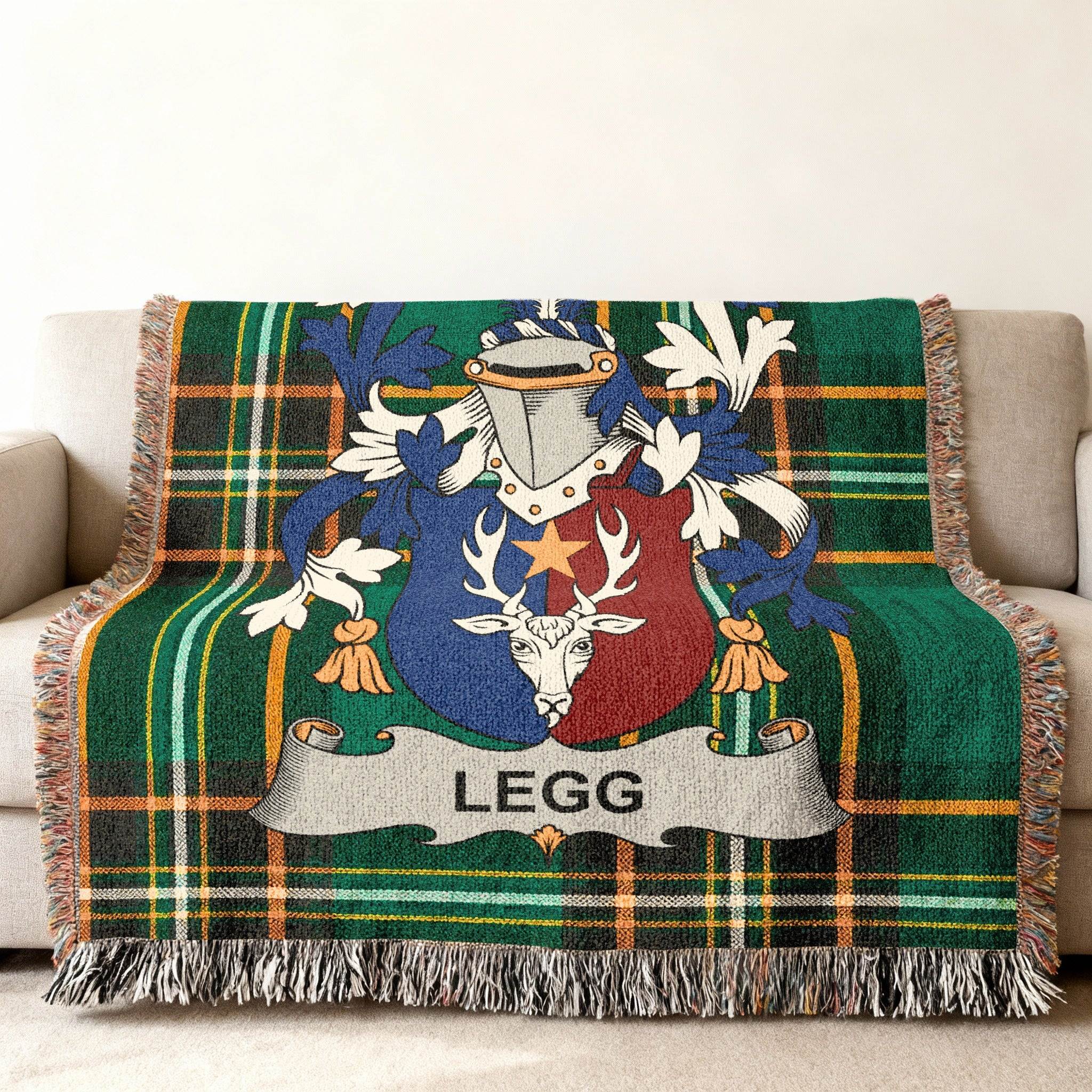 Green plaid blanket with family crest featuring a deer and shield, text "LEGG".