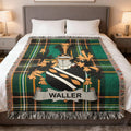 Tartan blanket featuring the Waller family crest on a bed.
