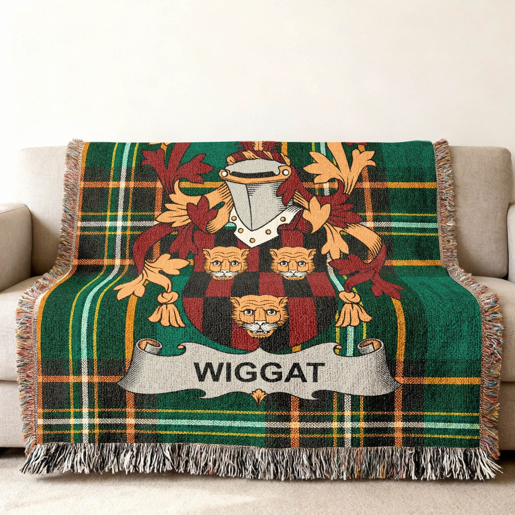 Wigget family crest on green plaid throw blanket with fringe.