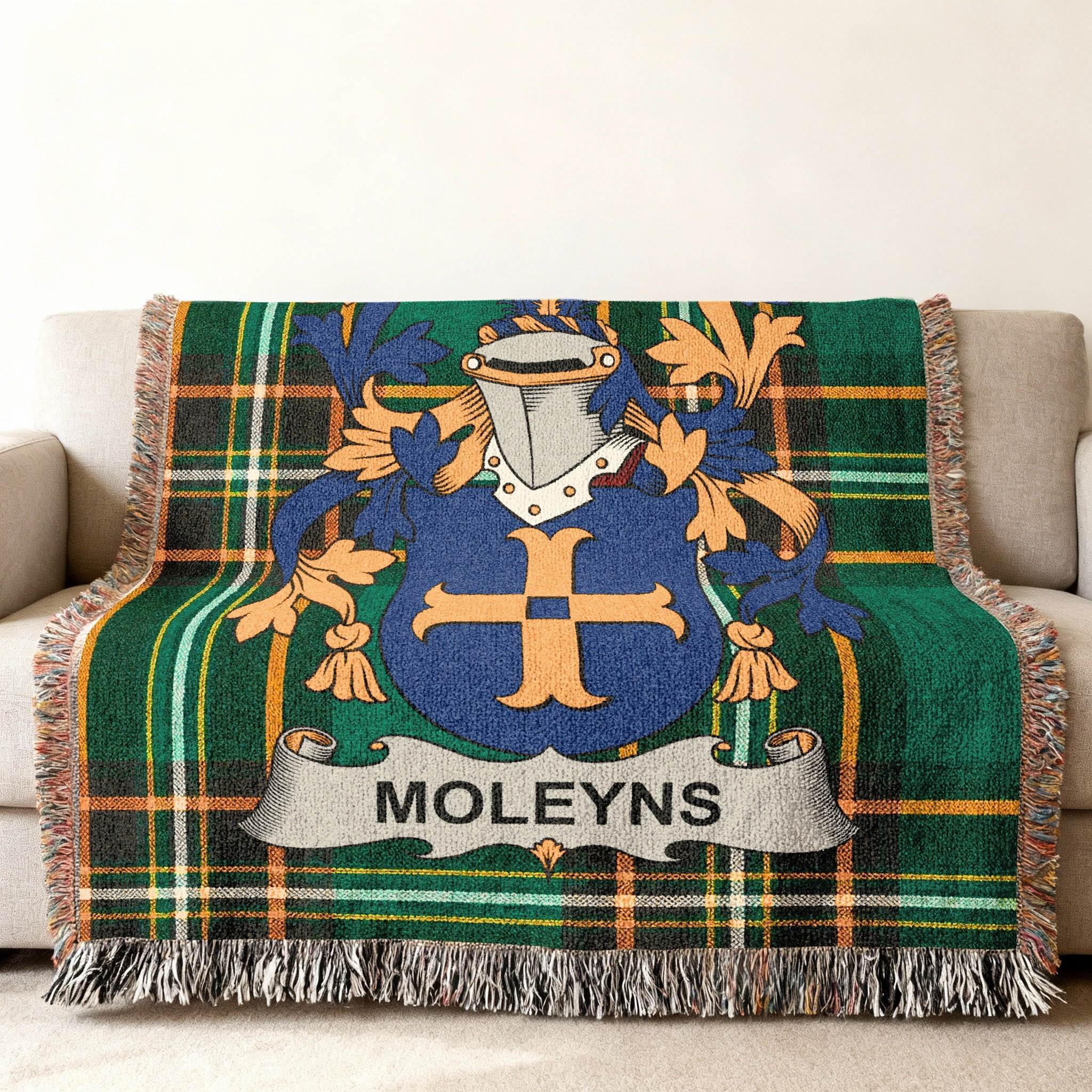 Woven tartan throw blanket with a blue and gold family crest and MOLEYNS name banner.