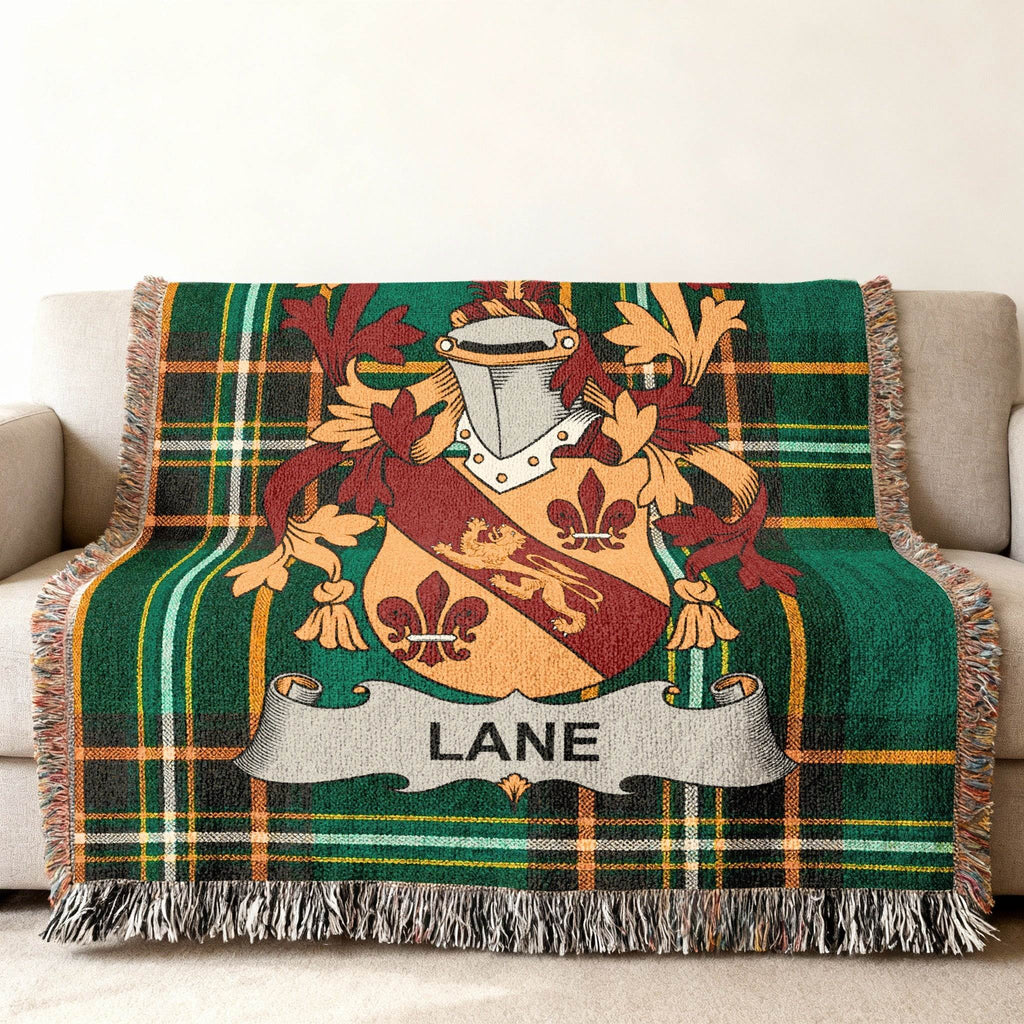 Green plaid blanket with Lane family crest and fringe.
