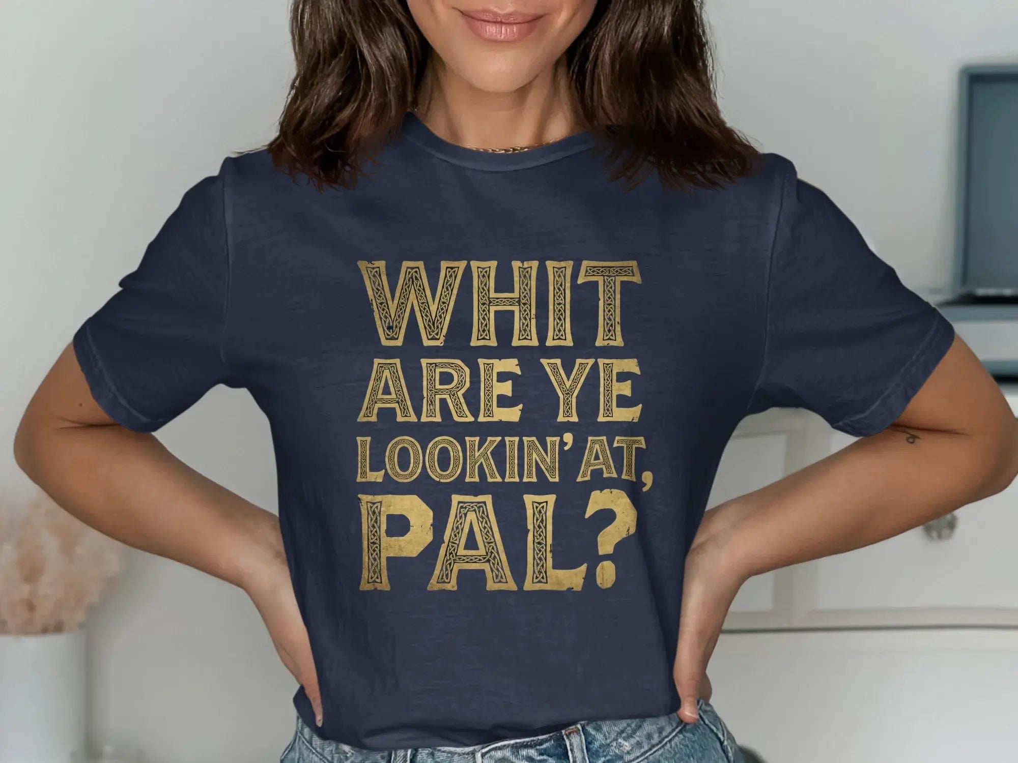 Navy t-shirt with gold text reading "WHIT ARE YE LOOKIN' AT, PAL?".