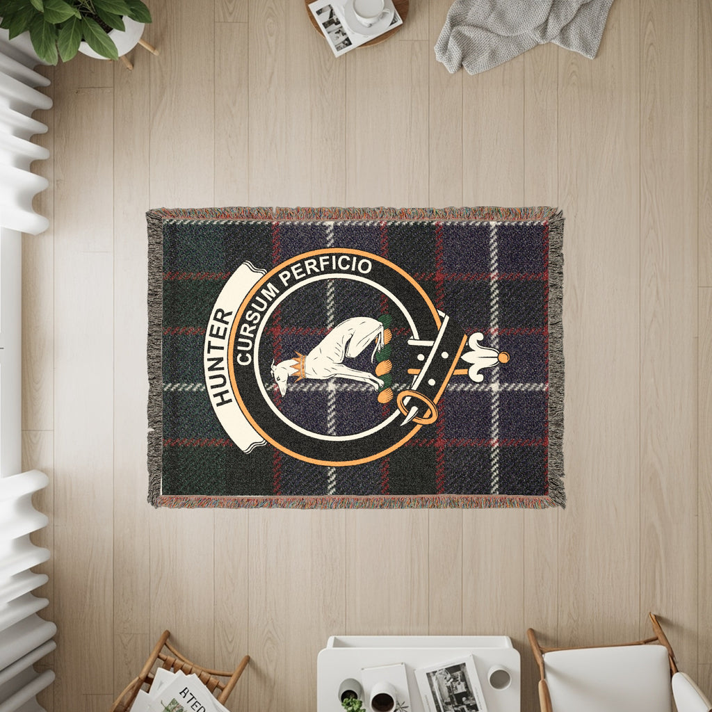 Tartan blanket with the Hunter clan crest featuring a dog and the motto "Cursum Perficio".