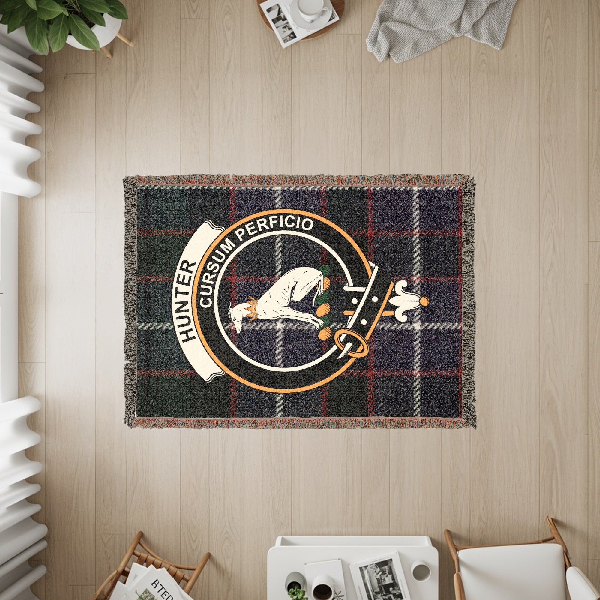 Tartan blanket with the Hunter clan crest featuring a dog and the motto "Cursum Perficio".