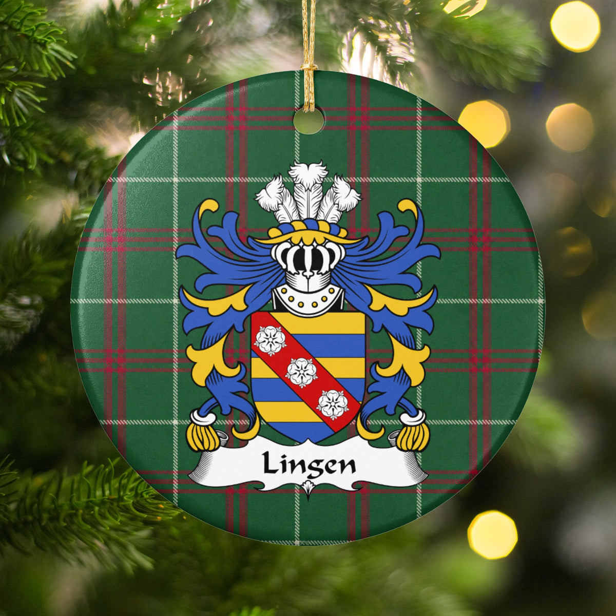 Lingen ornament hanging on a Christmas tree among green branches and warm lights, with a blue-and-gold striped shield with three white roses on a red diagonal band on Welsh national tartan.